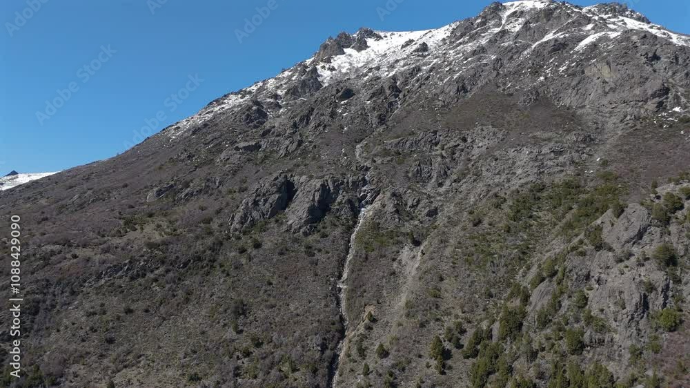 Aerial view of snowy rocky mountain with waterfall on Route 40, San Martin de los Andes, Patagonia, Neuquén, Argentina Aerial view of snowy rocky mountain with waterfall on Route 40, San Martin de los Andes, Patagonia, Neuquén, Argentina