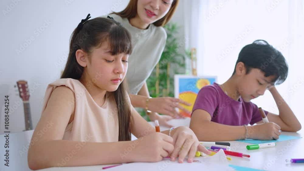 Asian teacher educating students in an art class at elementary school. Asian teacher educating students in an art class at elementary school.