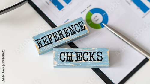 Reference Checks text on wooden block on office background