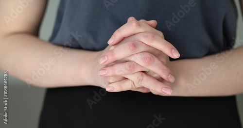 Closeup of woman hands clasped in prayer