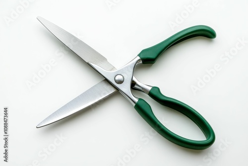 Green-handled scissors on white background.