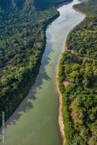 Beautiful natural scenery of river in southeast Asia tropical green forest with mountains in background, aerial view drone shot - generative ai