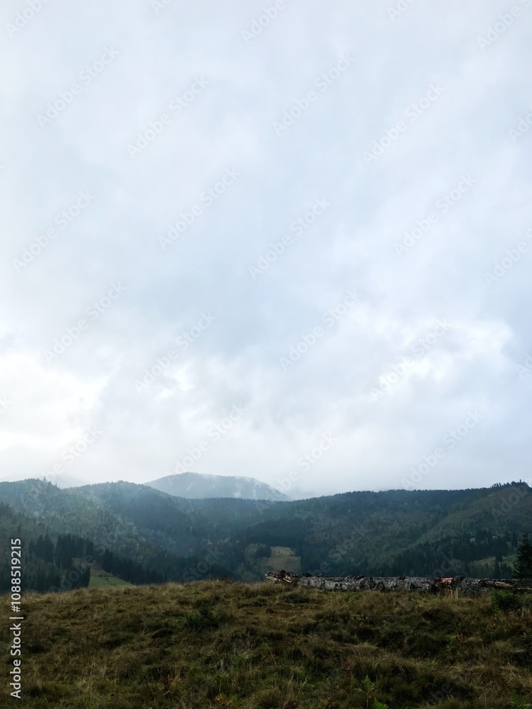 Scenic mountain landscape with cloudy sky and vast horizon Scenic mountain landscape with cloudy sky and vast horizon