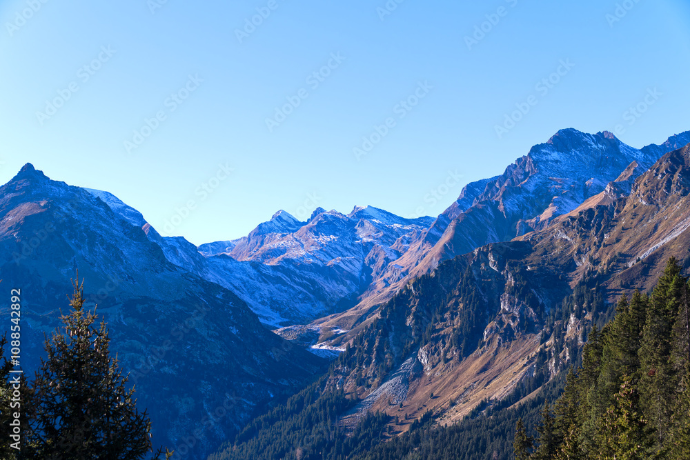 Beautiful mountain panorama in the Swiss Alps with Bregaglia Valley seen from viewpoint of mountain village Maloja on a sunny autumn day. Photo taken November 15th, 2024, Maloja, Switzerland.