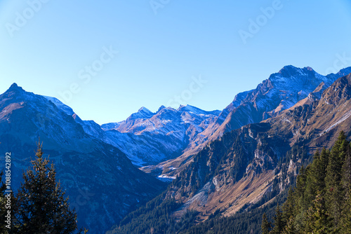 Beautiful mountain panorama in the Swiss Alps with Bregaglia Valley seen from viewpoint of mountain village Maloja on a sunny autumn day. Photo taken November 15th, 2024, Maloja, Switzerland.