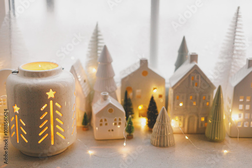 Cuadro en lienzo Glowing christmas lantern with golden lights bokeh and holiday decorations on window sill