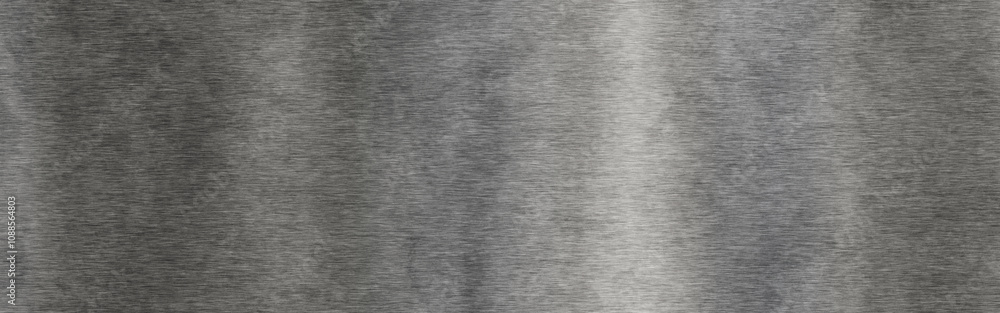 Silver brushed texture with subtle gradients on a metal surface in natural light Silver brushed texture with subtle gradients on a metal surface in natural light