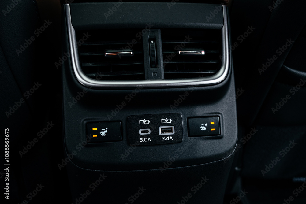 Modern brown car interior, leather steering wheel, climate control, large navigation screen, air ducts, deflectors on the car panel. Interior details. Modern brown car interior, leather steering wheel, climate control, large navigation screen, air ducts, deflectors on the car panel. Interior details.
