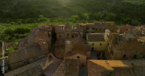 Red Brick Roofs With Bell Tower Of Church At Castelmuzio In Val d'Orcia, Siena, Tuscany, Italy. Aerial Drone Shot photo