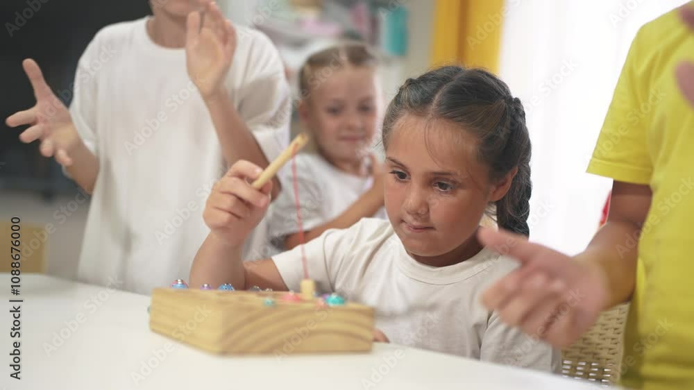 child girl group playing fishing. a group of children collect building blocks in a kindergarten indoors. children in kindergarten play with toys. lifestyle happy family kid dream concept child girl group playing fishing. a group of children collect building blocks in a kindergarten indoors. children in kindergarten play with toys. lifestyle happy family kid dream concept