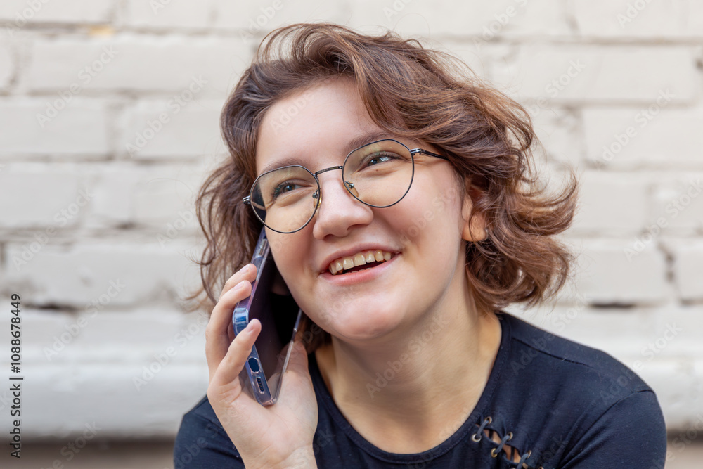 Happy young woman talking on the phone. Emotion concept. Close-up. Happy young woman talking on the phone. Emotion concept. Close-up.