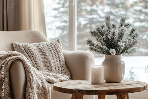 Cozy Living Room with Sofa, Knit Blanket, Wooden Side Table, Candle and Winter Wonderland View through Large Window photo