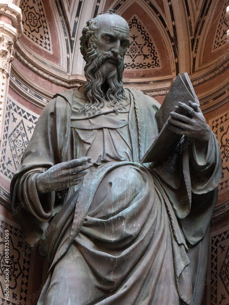 Obraz premium The bronze statue of St. John the Evangelist from the year 1515 by Baccio da Montelupo in the external niches of the church of Orsanmichele in Florence, Italy.