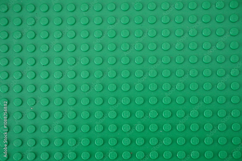 Naklejka premium Green plastic Lego board