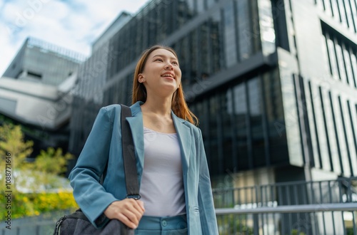 Portrait of a young and confident businesswoman standing in front a modern office building in the financial district