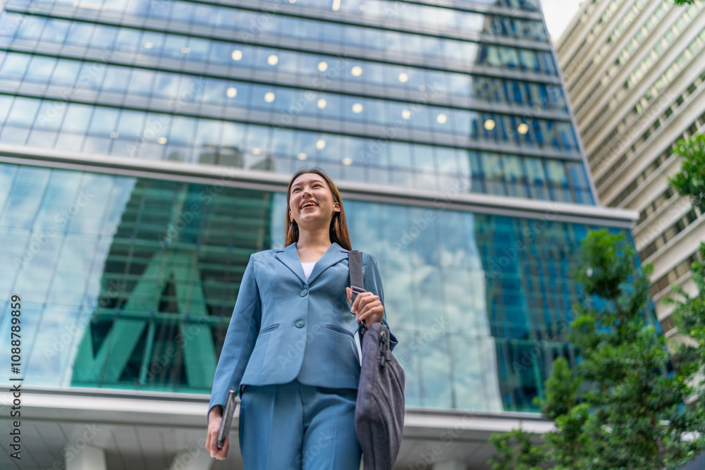 Portrait of a young and confident businesswoman standing in front a modern office building in the financial district Portrait of a young and confident businesswoman standing in front a modern office building in the financial district