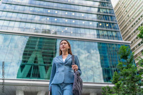 Portrait of a young and confident businesswoman standing in front a modern office building in the financial district