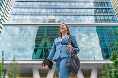 Portrait of a young and confident businesswoman standing in front a modern office building in the financial district