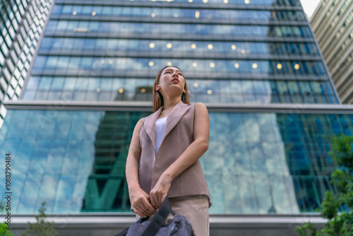 Portrait of a young and confident businesswoman standing in front a modern office building in the financial district