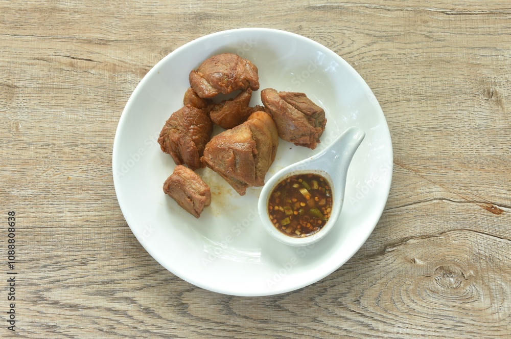 fried crispy slice fat pork in fish sauce on plate dipping with chili sauce fried crispy slice fat pork in fish sauce on plate dipping with chili sauce