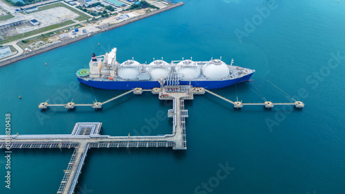 LNG (Liquified Natural Gas) tanker anchored in Gas terminal gas tanks for storage. Oil Crude Gas Tanker Ship. LPG at Tanker Bay Petroleum Chemical or Methane freighter export import transportation