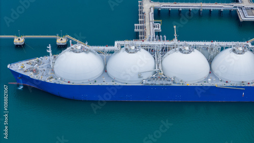 LNG (Liquified Natural Gas) tanker anchored in Gas terminal gas tanks for storage. Oil Crude Gas Tanker Ship. LPG at Tanker Bay Petroleum Chemical or Methane freighter export import transportation photo