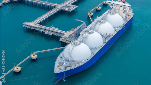 LNG (Liquified Natural Gas) tanker anchored in Gas terminal gas tanks for storage. Oil Crude Gas Tanker Ship. LPG at Tanker Bay Petroleum Chemical or Methane freighter export import transportation