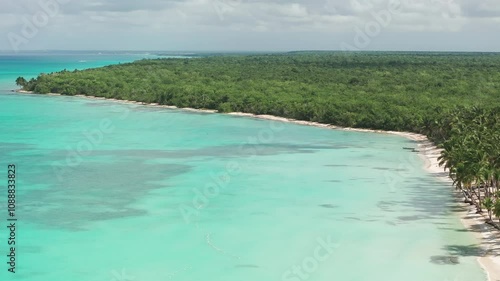 Nice drone shot of Saona Island in Dominican Republuc. Caribbean Sea with clear turquoise water and green palms photo