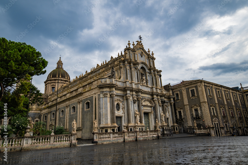 The exterior of Catania Cathedral on a rainy, cloudy day without people in Sicily, Italy. Stock photo The exterior of Catania Cathedral on a rainy, cloudy day without people in Sicily, Italy. Stock photo