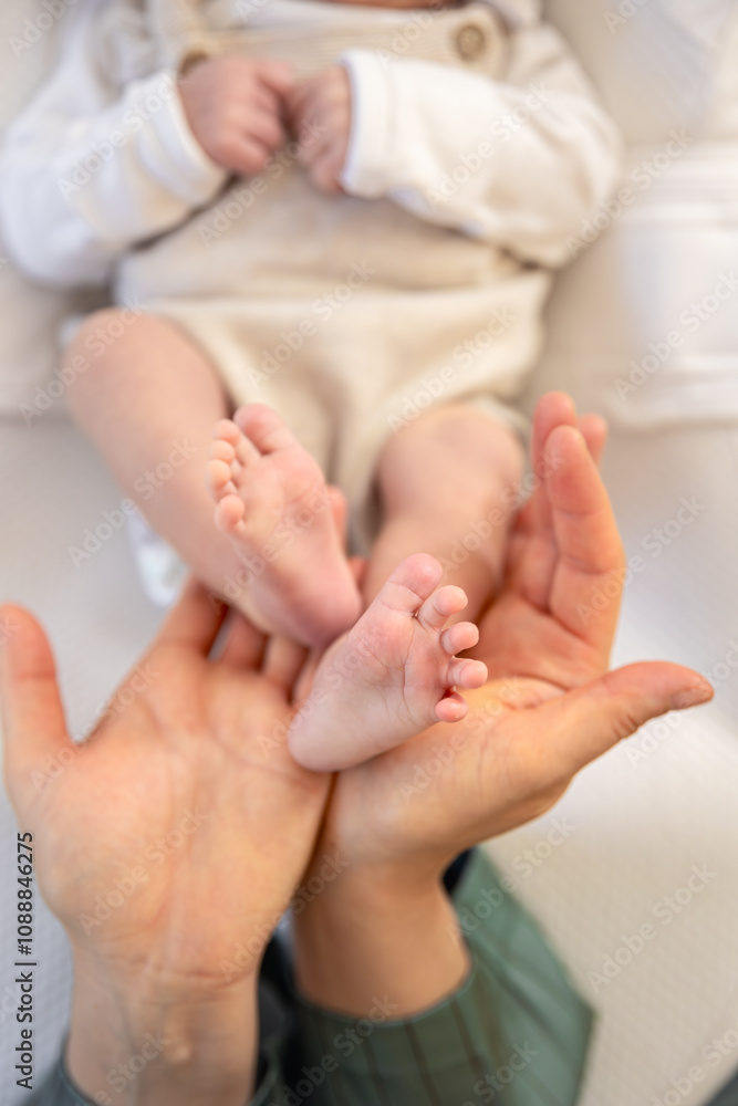 Parent holding in the hands feet of newborn baby. Mom holding baby feet. Parent holding in the hands feet of newborn baby. Mom holding baby feet.