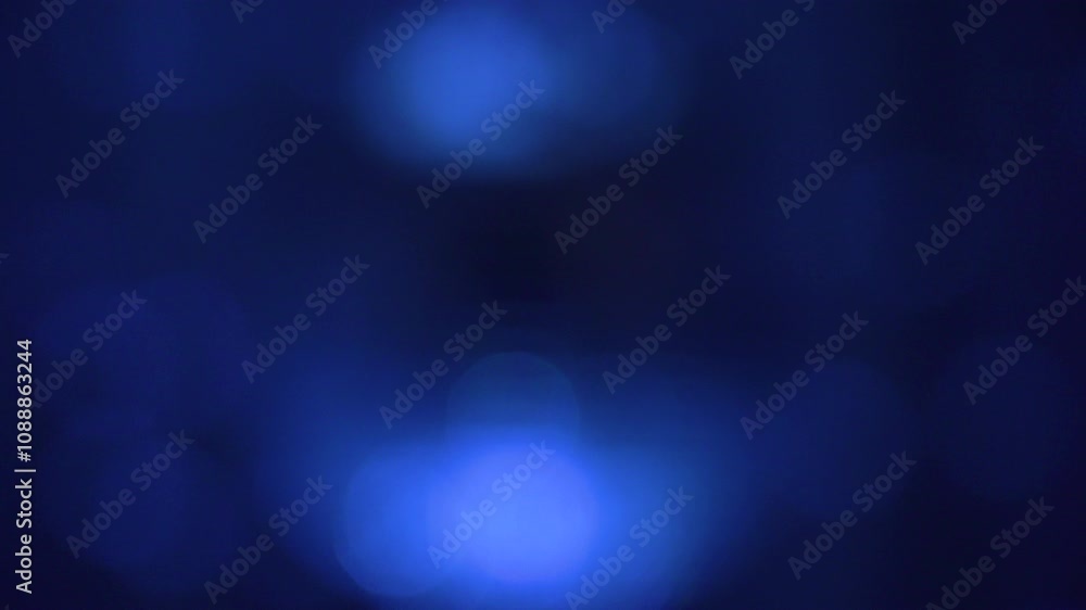 Swirling blue lights dance in a dark atmosphere creating an immersive visual experience during evening performance Swirling blue lights dance in a dark atmosphere creating an immersive visual experience during evening performance