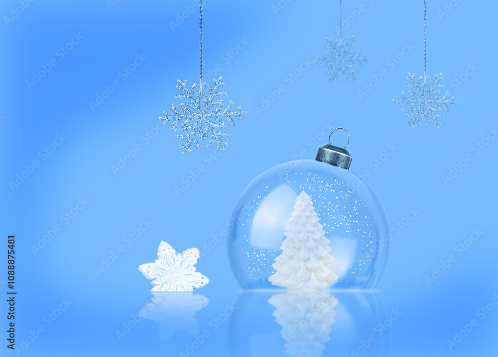 Christmas card. Transparent snow globe with Christmas tree and snow inside on blue background. Christmas card. Transparent snow globe with Christmas tree and snow inside on blue background.