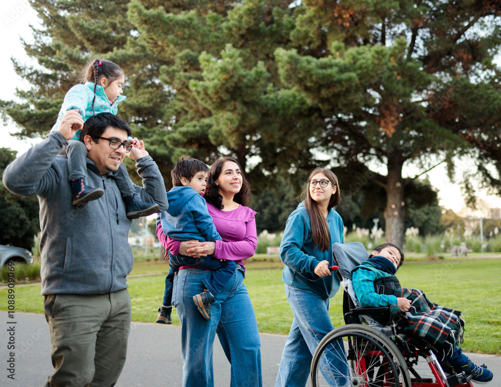 Latin Family enjoying a day at the park under sunny skies Latin Family enjoying a day at the park under sunny skies