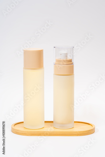 Elegant cosmetic packaging bottles on wooden tray photo