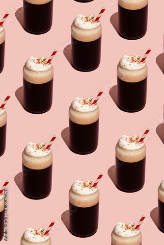 Pattern of frothy coffee with cream on pink background photo