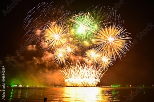 Beautiful fireworks set off in the middle of the sea.