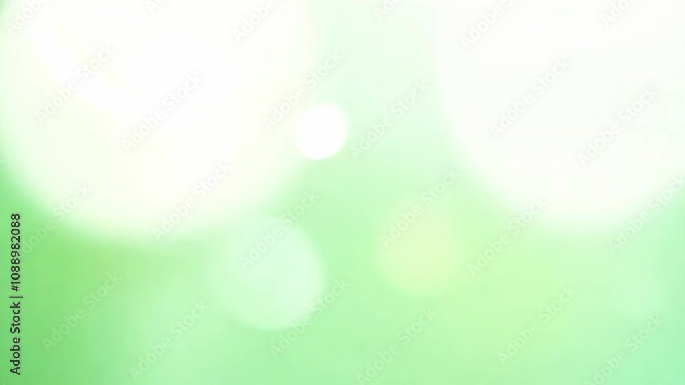 Abstract green bokeh background with soft light circles. Suitable for themes like relaxation, tranquility, or nature-inspired concepts with ample copy space.