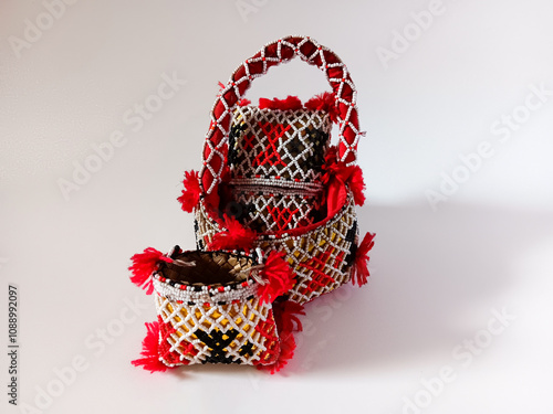 Decorated hand basket bags woven beads aka gajut or hajut for the traditional Bataknese bridal procession isolated on white background. photo