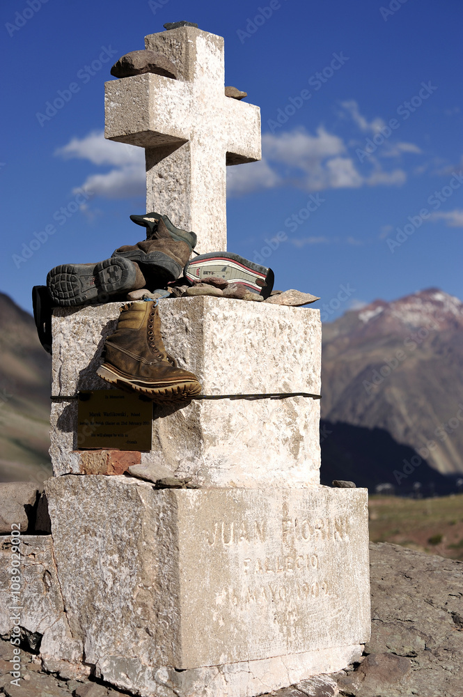 A stone cross statue erected in memory of Juan Florini in the mountains A stone cross statue erected in memory of Juan Florini in the mountains