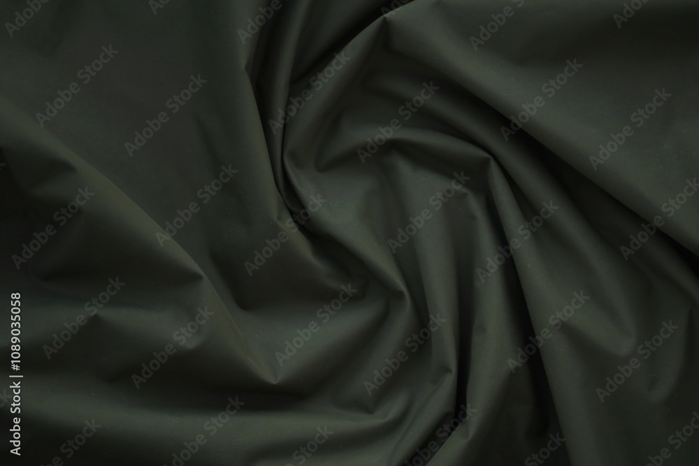 Obraz premium Texture of Dark green military uniform textile cloth with folds