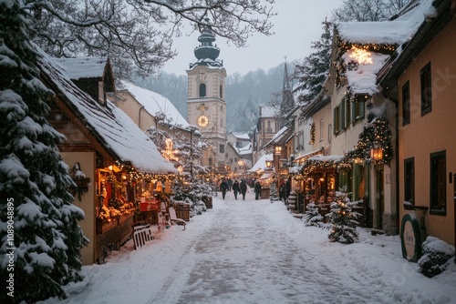 Christmas market stalls illuminated at twilight in snowy square photo