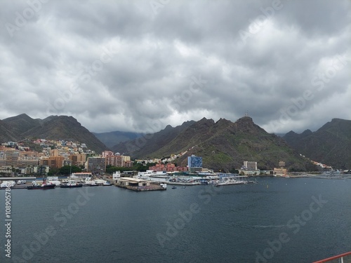 SPAIN Santa Cruz de Tenerife APR 22 2024Scenic Coastal City with Mountains and Cloudy Sky photo