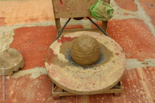 Preparing clay for making traditional pots like kulhad, katori, and diya, highlighting the initial step of pottery in Indian craftsmanship, selective focus  photo