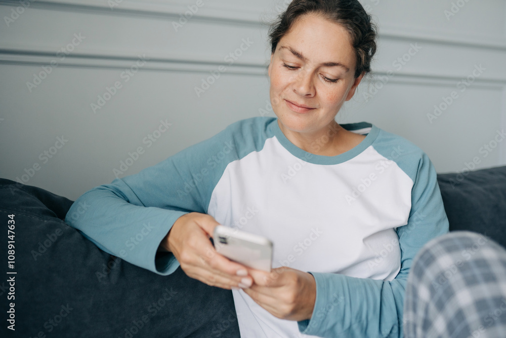 Portrait of a forty-year-old woman using a mobile phone to communicate online. Portrait of a forty-year-old woman using a mobile phone to communicate online.
