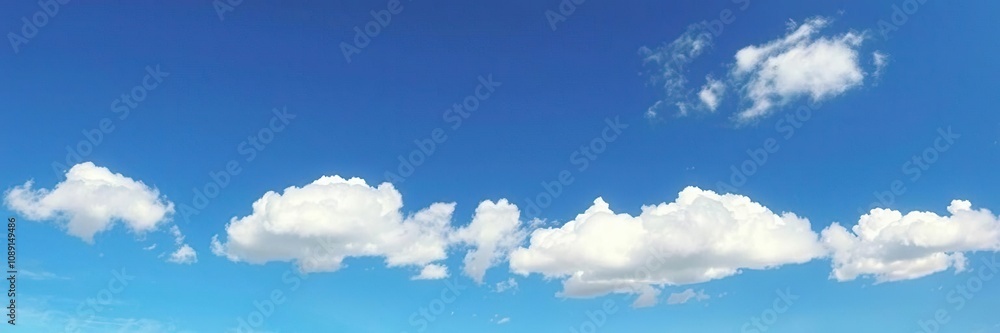 Soft white clouds drift lazily across a clear blue sky on a warm sunny day, peaceful, sky background Soft white clouds drift lazily across a clear blue sky on a warm sunny day, peaceful, sky background