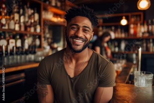 Smiling portrait of a young African American male bartender