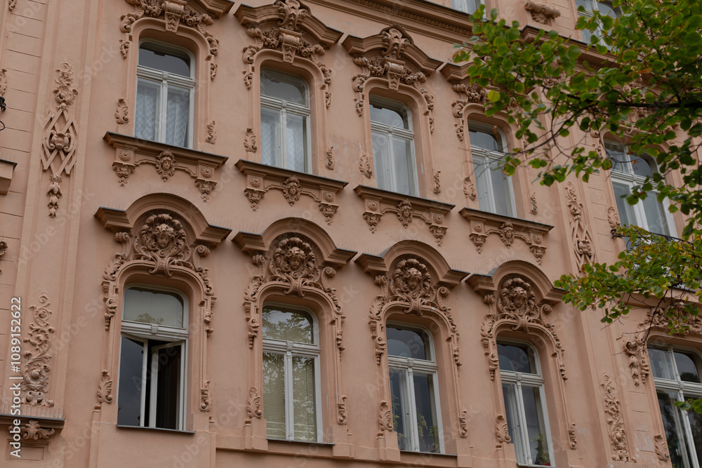 This detailed architectural facade boasts intricate carvings and beautifully decorative windows. It is perfect for those who are enthusiasts of historical architecture and appreciate craftsmanship This detailed architectural facade boasts intricate carvings and beautifully decorative windows. It is perfect for those who are enthusiasts of historical architecture and appreciate craftsmanship