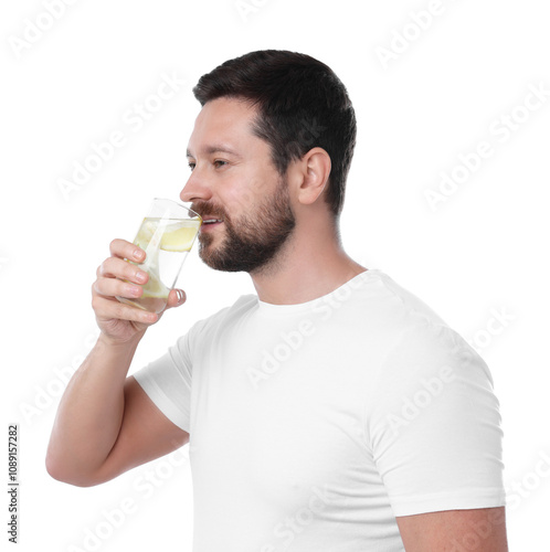 Handsome man drinking water with lemon on white background