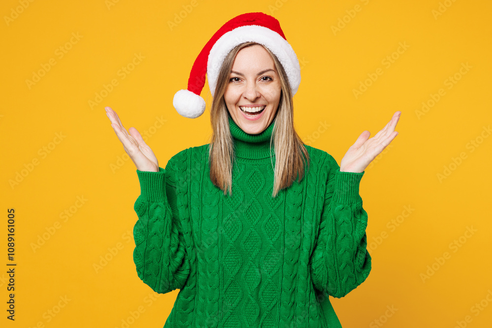 Merry shocked surprised young woman wears green warm cozy sweater Santa hat posing look camera spread hands isolated on plain yellow background. Happy New Year celebration Christmas holiday concept. Merry shocked surprised young woman wears green warm cozy sweater Santa hat posing look camera spread hands isolated on plain yellow background. Happy New Year celebration Christmas holiday concept.
