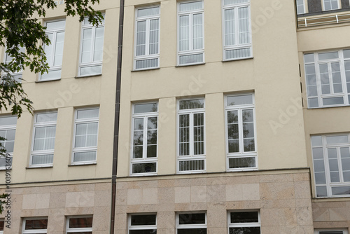 The facade of a contemporary building presents a striking modern aesthetic, featuring multiple windows and unique architectural elements that capture the attention of anyone passing by photo